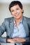 Dedicated business woman. Portrait of dedicated business woman smiling at office desk.