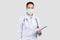 Dedicated Caucasian millennial doctor wearing a surgical mask and a stethoscope
