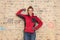 Dedicated craftswoman in front of brick wall in bare brickwork