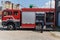 A dedicated firefighter preparing a modern firetruck for deployment to hazardous fire-stricken areas, demonstrating