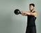 Dedicated to staying in shape. Studio shot of a young man working out with a kettle bell against a gray background.