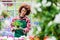 Dedicated woman holding a potted plant during work as florist