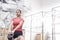 Dedicated woman lifting kettlebell in crossfit gym