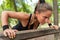 A dedicated woman performs push-ups in a serene park, showcasing her commitment to fitness and well-being