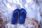 Deep blue color slippers on beach sand