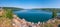 Deep blue lake against the backdrop of gently sloping green ridges