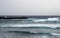 Deep blue ocean waves in a winter seascape with surf breaking