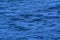 Deep blue rippling water surface background