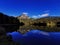 Deep blue Swiss lake mirroring mountain