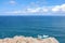 Deep blue water of calm Atlantic Ocean with clouds and blue sky.