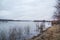 Deep calm river in the spring evening against a cloudy sky