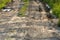 A deep car track on a Russian dirt road after rain. The imprint of car tires on the dirt. Dried mud on the roads in the village