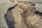 Deep clay ravine. Water erosion of the soil. Closeup