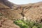 Deep creek and road in Dades Gorge valley