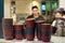 Deep dishes stacked in piles on a kitchen counter in a fast food restaurant. Cooks on a blurred background