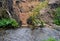 Deep excavation flooded by water when the pipeline failed. mining of sand, gold by the stream, panning illegal. mineral extraction