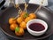 Deep-fried cream cheese balls with berry sauce