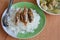 Deep fried fish topping on rice and pickled Chinese cabbage with pork entrails soup