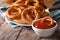 Deep fried onion rings and ketchup closeup. horizontal