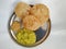 Deep fried Poori or Puri served with spicy potato onion curry and Coconut Chatney. It is an unleavened deep-fried bread