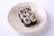 Deep Fried Salmon skin maki sushi on ceramic dish isolated on white background
