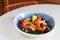 deep-fried shrimp with exotic fruits in a bowl on the table, salad