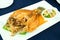 Deep fried snapper topped with sweet fish sauce and vegetable serve on white dish - homemade food concept