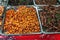 Deep fried spicy silk worms and insects at night street market, selective focus