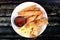 Deep fried spring roll,and frence fries sreved with tomato souce and chili sauce.