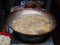 Deep fried tofu cooking in big pan or wok filled with frying oil. Street food stall in Vietnam, junk unhealthy eating