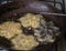 Deep frying kokis or rosette cookies, crispy sri lankan food closeup view