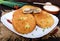 Deep frying pies with meat on a white plate with sour cream