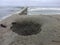 Deep hole in the sand