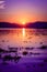 Deep majestic purple sunset reflecting over a rippled Lake Chapala in Ajijic Mexico