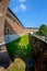 A deep moat and high wall of an ancient fortress Castello Sforzesco Sforza Castle in Milan