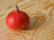 Deep orange pumpkin lying on a wooden table top