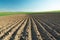 Deep plowing on the farmland, horizon and blue sky