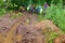 Deep puddle in the forest, cyclists and big puddle in the forest, travel by bike