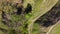 Deep ravine with steep clay slopes, aerial vertical view