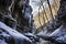 a deep, shadowy cave canyon with icicles