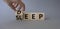 Deep Sleep symbol. Doctor hand turns wooden cube and changes word Sleep to Deep. Beautiful grey background. Medicine and Deep