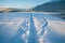 Deep snow trail paths in sunlit alpine winter landscape in Wildermieming  Tirol  Austria