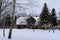 Deep snow, where you can see some trees and an old abandoned wooden building