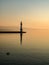 Deep sunrise light illuminating the lighthouse of Geneva harbour.