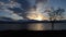 Deep vibrant sunset over snowy mountain island landscape and colorful reflection on the fjord surface in the arctic circle