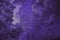 Deep violet winter background or wallpaper. Rich saturated flashy color. Tinted purple grainy backdrop in dark and light tones.