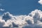 Deep volumetric landscape of the blue sky with huge piles of white dense clouds. It looks very unusual and beautiful.