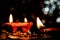 Deepawali concept. Low light Photo of two blurred earthen lamps with one lamp in the foreground and some coins on the floor