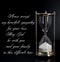 Deepest condolence white sand timer on black background with text