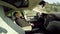 Deeply asleep businessman behind the steering wheel in self-driving electric car